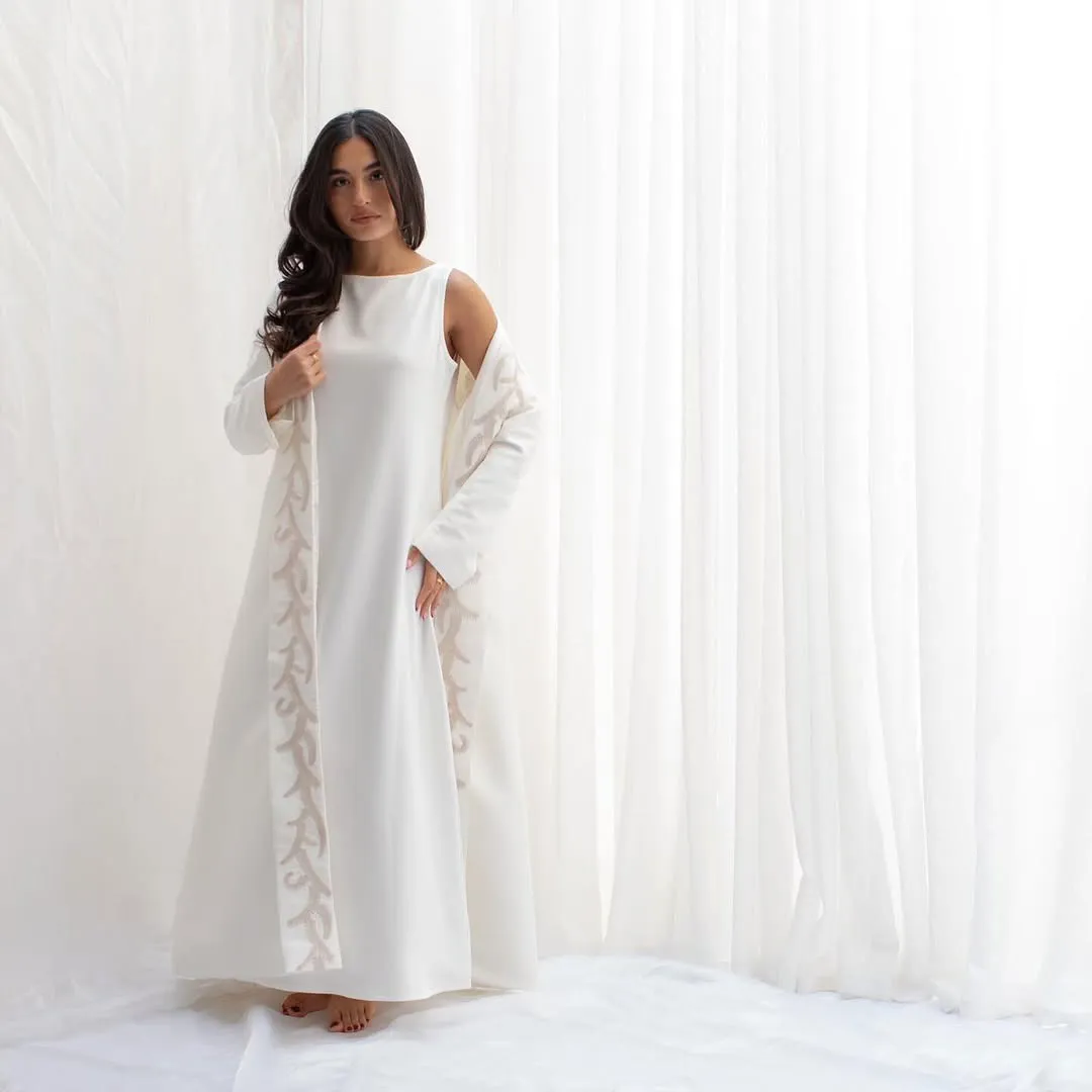 Ivory embroidered bisht set against white curtains