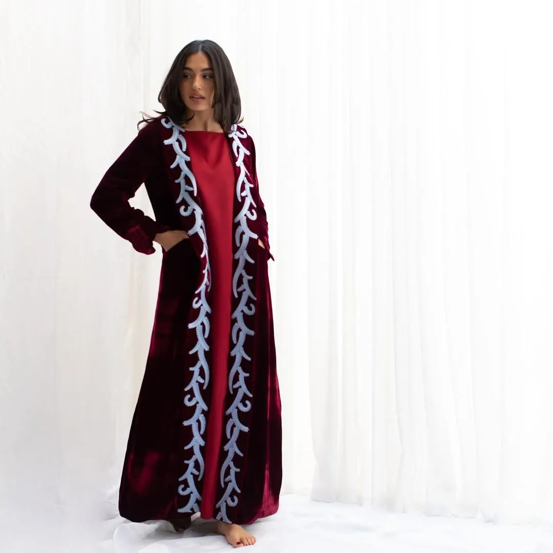 Burgundy velvet open robe with pale blue scroll trim over a red long dress